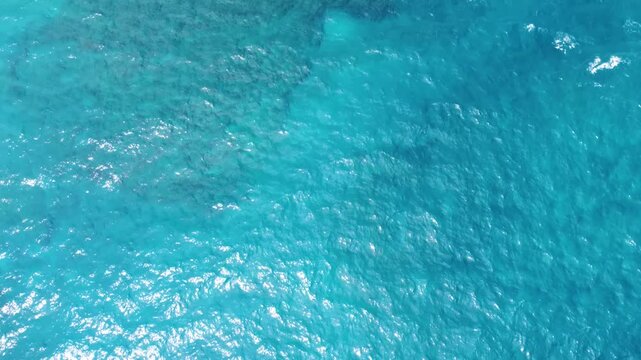 Hamoa Beach Hana Maui Hawaii &ndash; A cinematic tilt up reveal aerial video featuring pristine clear blue waters, large waves, tropical greenery, and rugged lava rocks. A must-see Maui beach destination