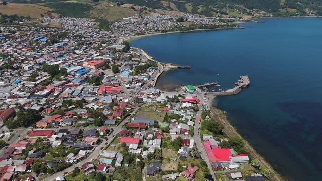 Aerial view of Ancud, a charming city on Chiloe Island, Chile, showcasing its colorful houses, streets, and pier against the backdrop of the Pacific Ocean