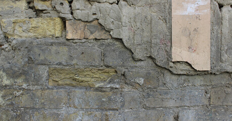 Remains of old cement mortar, cracked bricks and tiles in old masonry