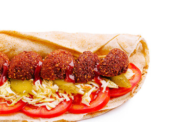 Falafel wrap filled with fresh vegetables and sauces for lunch