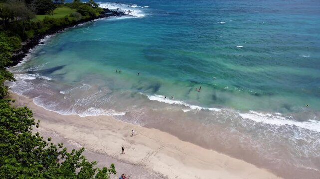 Hamoa Beach Hana Maui Hawaii &ndash; A cinematic aerial experience showcasing the crystal-blue ocean, large waves, and lush Hana greenery at this famous Maui surf destination