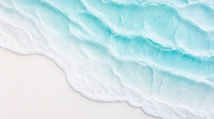 Obraz premium Soft waves ripple and kiss the sandy shore, showcasing clear turquoise waters and white foam in a calm tropical environment during midday