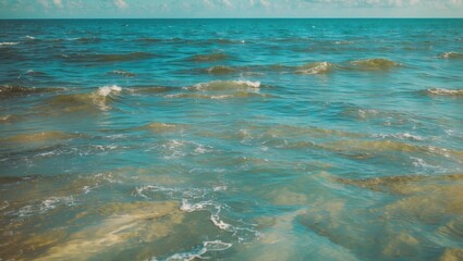 Obraz premium Tranquil blue ocean waves creating a serene water texture with ample empty space for personalized text or branding messages.
