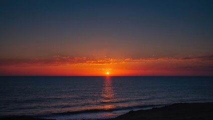 Fototapeta premium Vibrant sunset over calm ocean waters creating a serene nighttime seascape with colorful sky and gentle waves reflecting the light.