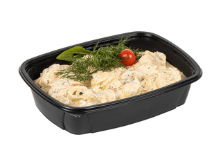 A black plastic container filled with food and topped with a tomato
