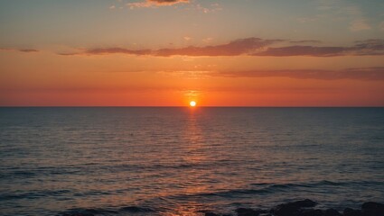 Fototapeta premium Serene Sunset Over Tranquil Sea with Vibrant Colors and Empty Space for Text or Copy