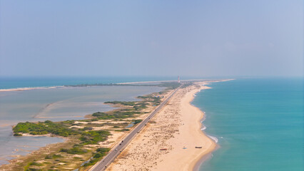A stunning drone view of Dhanushkodi’s scenic road stretching into the Indian Ocean with light house of Dhanushkodi image view