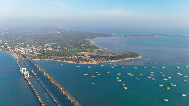 High-angle drone shot capturing the Pamban Railway Bridge with its stunning double-leaf bascule section, allowing ships to pass beneath. - Powered by Adobe