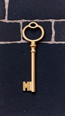 Unlocking potential a golden key on a dark brick background still life urban setting
