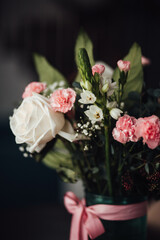 Bouquet of roses and carnations in a vase