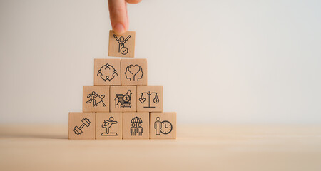 Employee wellbeing concept. Wooden blocks with physical, mental, emotional health icons. Creating...