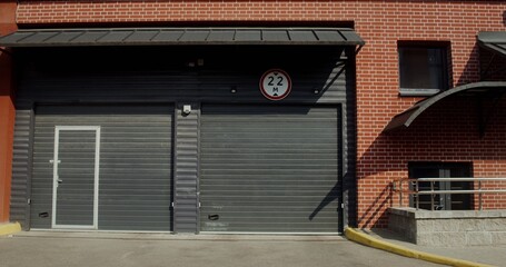 A young man with a paper bag in his hands drinks juice from a disposable cup with a straw while walking around the city