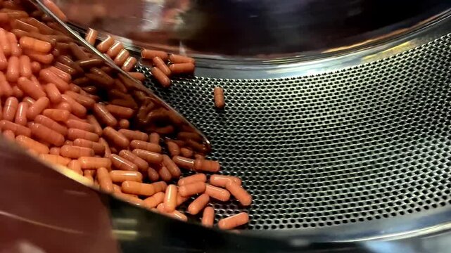 Automatic capsule tablet production line in pharmaceutical factory, Rotating machine Capsule medicine pills in the workshop of chemical factory.