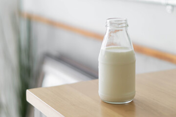 Closeup of  Milk Bottle on Wooden Table, selective focus, health care concept