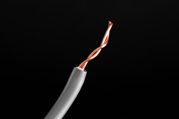 Grey stripped electrical wire on black background, closeup