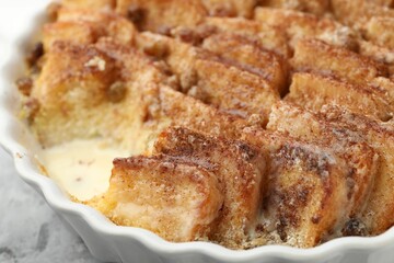 Delicious bread pudding with raisins and cinnamon on table, closeup
