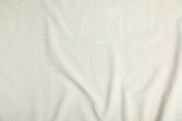 Texture of beige crumpled tablecloth as background, top view