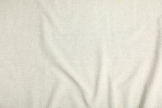 Fototapeta Texture of beige crumpled tablecloth as background, top view