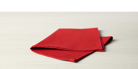 Red napkin on light wooden table against white background