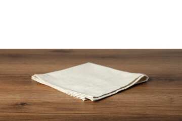 Light napkin on wooden table against white background