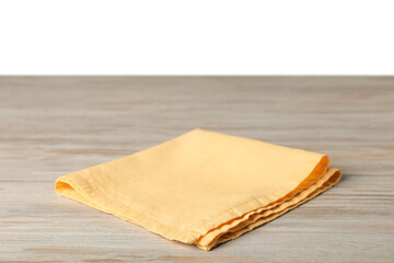 Yellow napkin on wooden table against white background