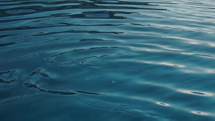 Naklejka premium Calm Blue Water Surface with Gentle Ripples - Serene Ocean or Lake Background