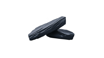 Two dark irregularly shaped objects, possibly rocks or cushions are shown against a plain white background.