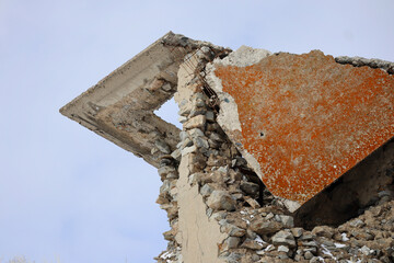 Old ruined stone building. Concrete and stone. Blue sky. Abstract architectural background