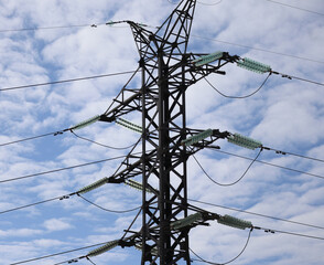 High-voltage power transmission tower. Blue sky background. Power lines