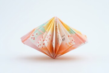 A folded paper sculpture displayed on a clean white background