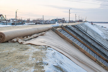 construction of a protective dam using roll materials and concrete to protect against spring floods...