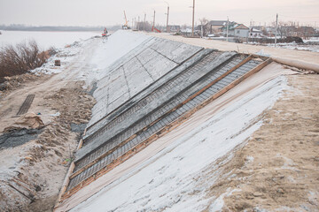 construction of a protective dam using roll materials and concrete to protect against spring floods and melt waters