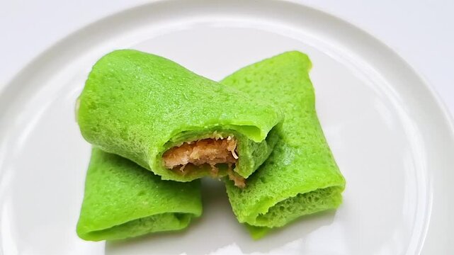 This Indonesian delicacy, Kue Dadar Gulung, is a rolled crepe generously filled with grated coconut and caramelized palm sugar.