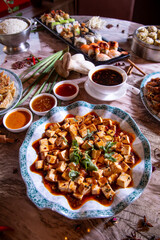 Gourmet Asian Food Platter Featuring Hot and Sour Soup, Dumplings, and Tofu