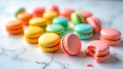 Obraz premium Colorful macarons on a marble surface, with one bitten, showcasing a vibrant array of pastel hues and textures in a minimalist setting.