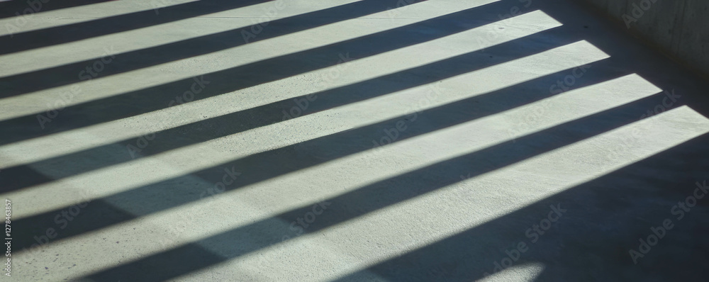 Poster shadows and texture of deep diagonal ribs on concrete surface