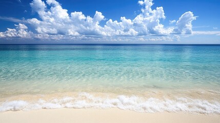 Fototapeta premium A dreamy tropical beach with crystal-clear water, soft white sand, and a distant horizon.