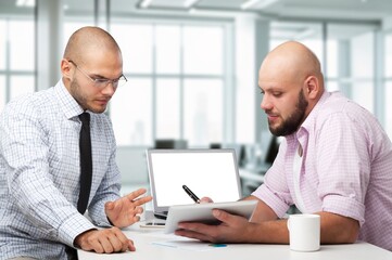 Fototapeta premium Inspired young entrepreneur talking to business partner