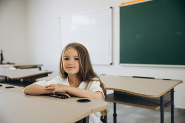 Young Girl Sitting in an Empty Classroom