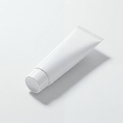 White, squeezable tube of cream or lotion, lying diagonally on a light backdrop. Simple and minimalistic design.
