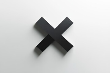 Obraz premium A black, cross-shaped sculpture rests against a smooth white surface. Shadows cast by its dimensionality add interest to the minimalist design, emphasizing form and contrast