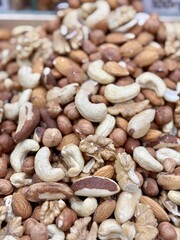 A nut mixture consisting of cashews, almonds, walnuts, hazelnuts on the store counter for sale in the supermarket