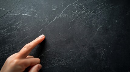 Finger pointing slate background texture