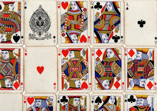 A montage of vintage playing cards in different suits.