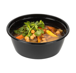 A black bowl of soup and vegetables on a white background