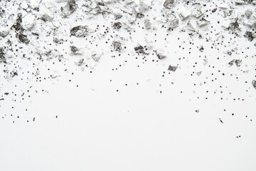 Obraz premium Crumbled white powder with black glitter on white background.