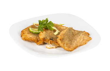 A white plate with delicious fried fish and lime wedges