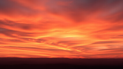 Fototapeta premium Horizon's Incandescent Embrace - A title that speaks to the warm, all-encompassing glow of the sunset, which seems to envelop and ignite the distant horizon