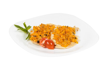 A plate of food with tomatoes and fresh mint on a white background