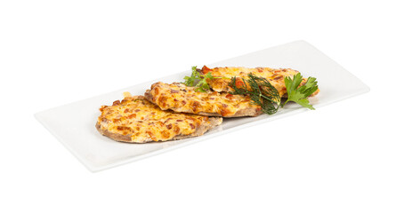 A white plate with chicken breasts and cheese on a white background